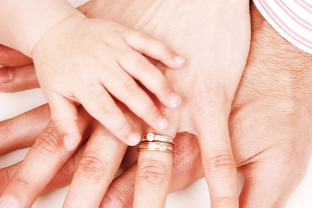 mother, father, and baby hands