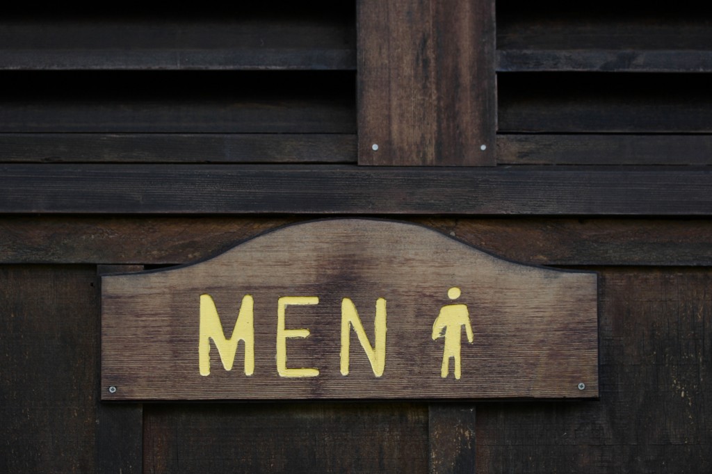 Engraved wooden men's bathroom sign. 